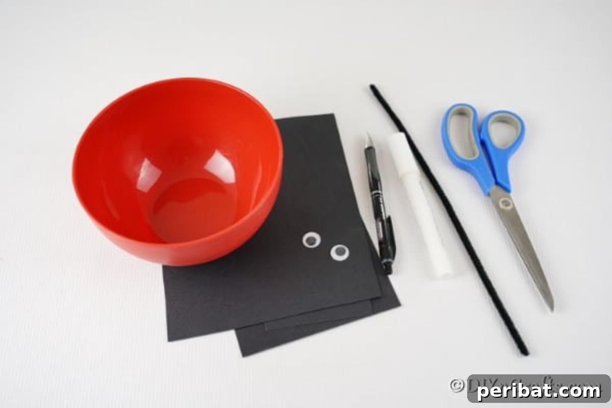 Repurposed Ladybug Bowl Art 6 Essential supplies laid out for creating the upcycled bowl ladybug craft, including a red bowl, black paper, googly eyes, pipe cleaners, and tools.