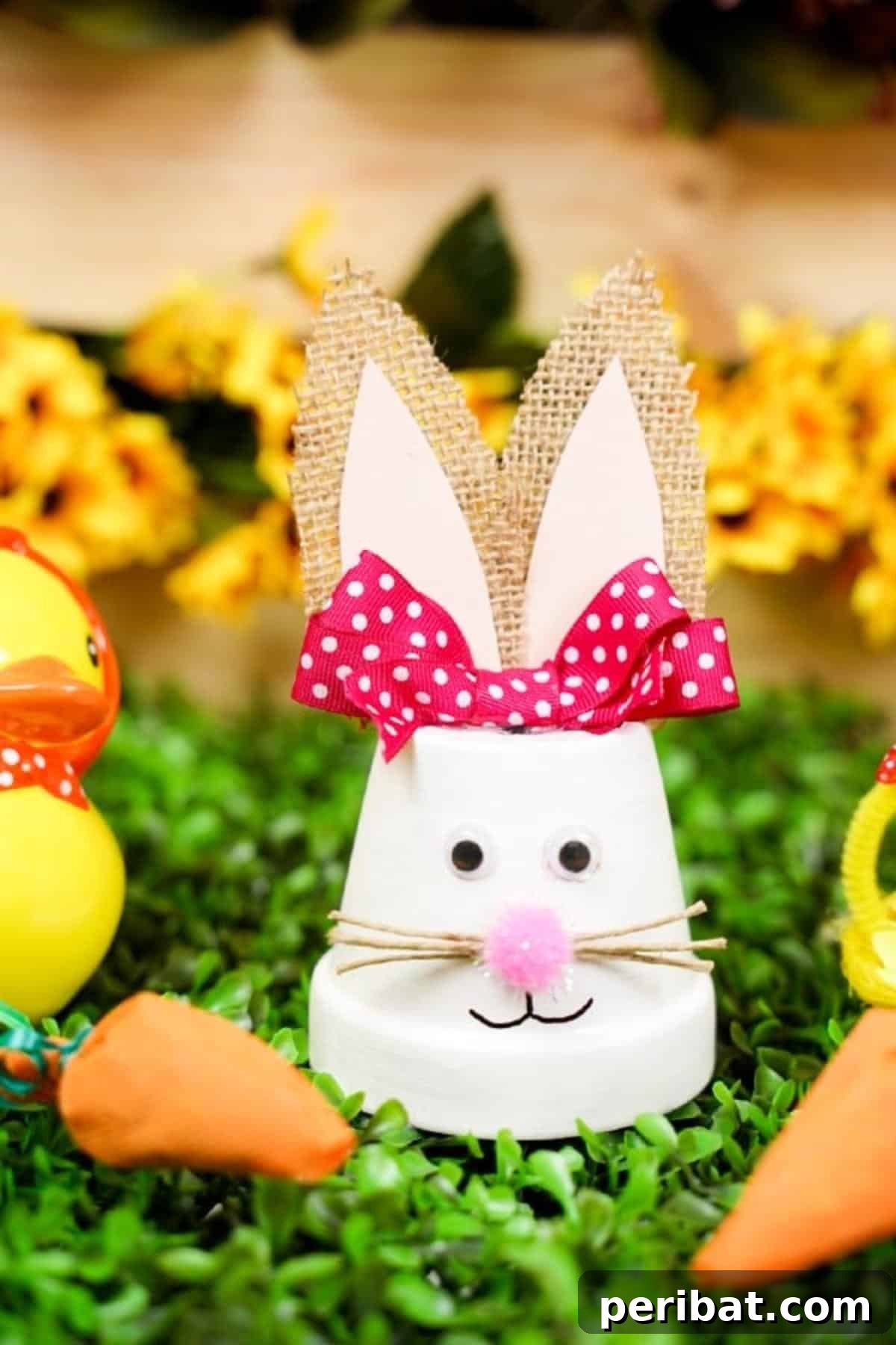 Charming Repurposed Planter Bunnies for Easter 15 Completed upcycled flower pot Easter bunny displayed on artificial grass with yellow flowers.