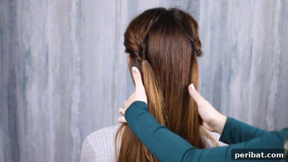 Rose-Kissed Low Bun Updo 12 Hands gathering all hair towards the nape of the neck, preparing to form a low ponytail for the updo.
