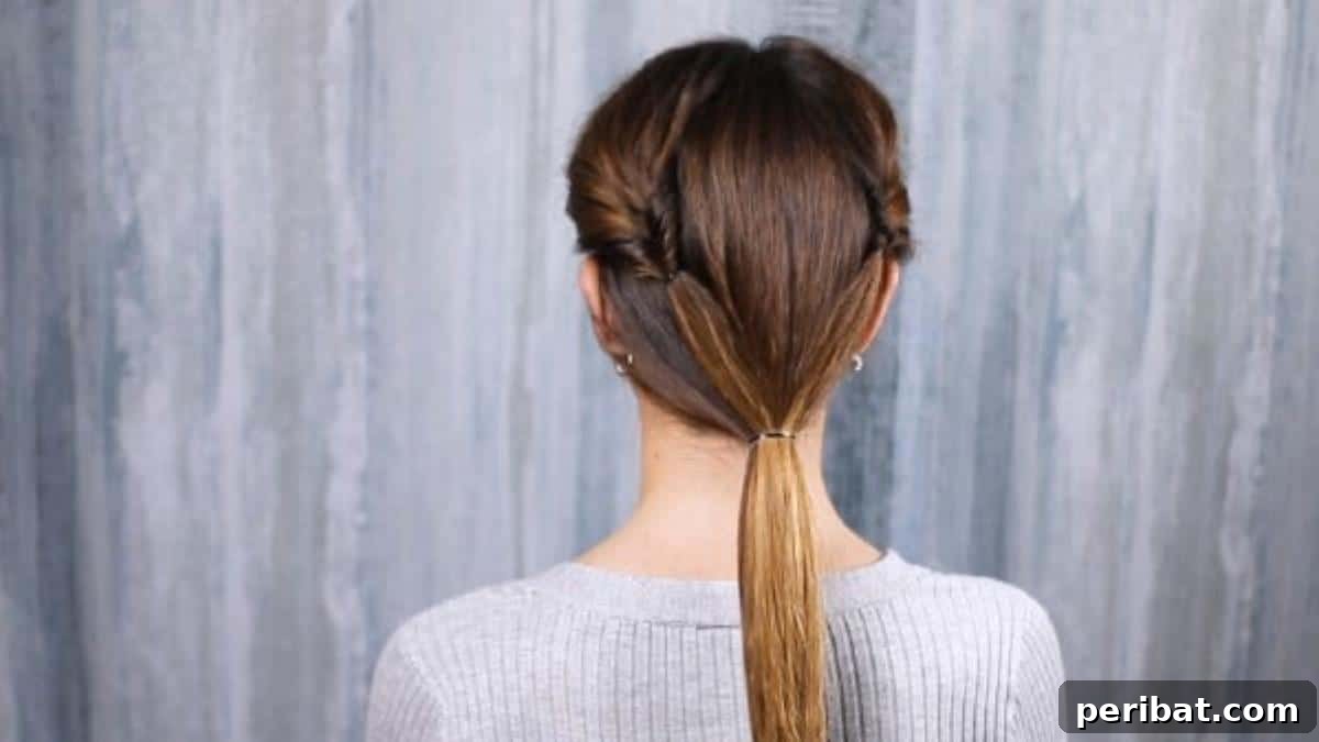 Rose-Kissed Low Bun Updo 13 All hair neatly secured in a low ponytail at the nape of the neck, ready for the next steps.