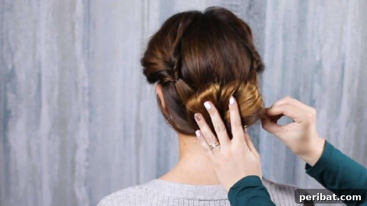 Rose-Kissed Low Bun Updo 18 Strategically securing the remaining loose ends of hair with bobby pins, completing the elegant low bun.