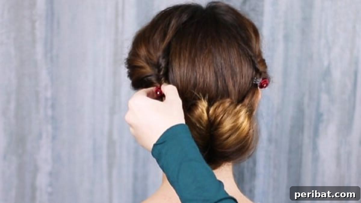 Rose-Kissed Low Bun Updo 19 Adding delicate rose clips along the sides of the finished low bun, enhancing its romantic appeal.