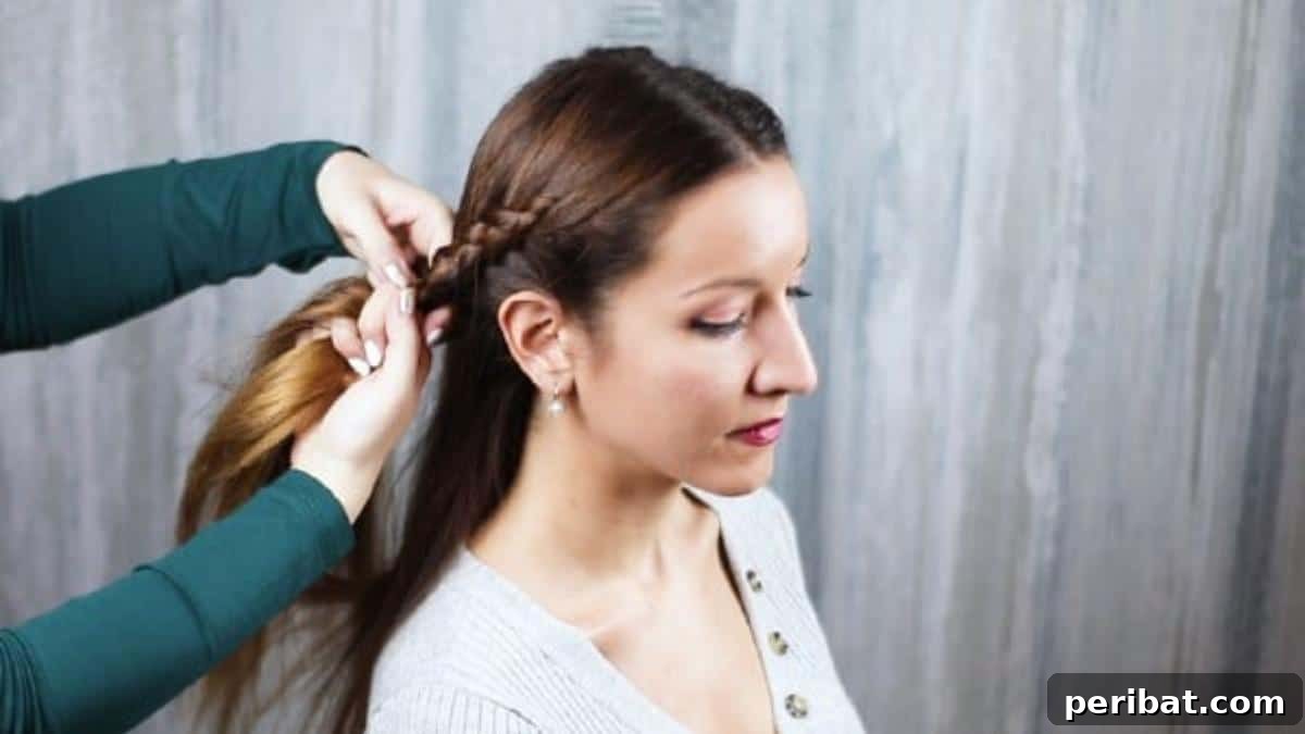 Gorgeous Double Dutch Braids: Step-by-Step Video Guide 12 Braiding the second section of hair, nearing the nape of the neck