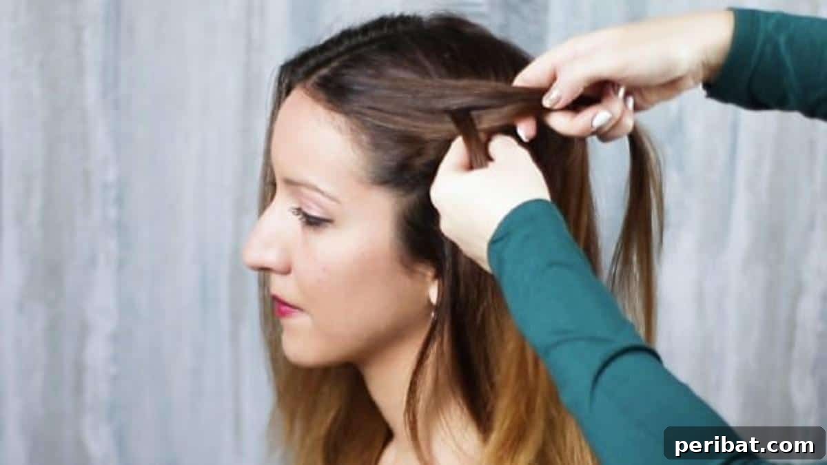 Gorgeous Double Dutch Braids: Step-by-Step Video Guide 7 Detailed shot of starting a Dutch braid by dividing hair into three sections near the forehead