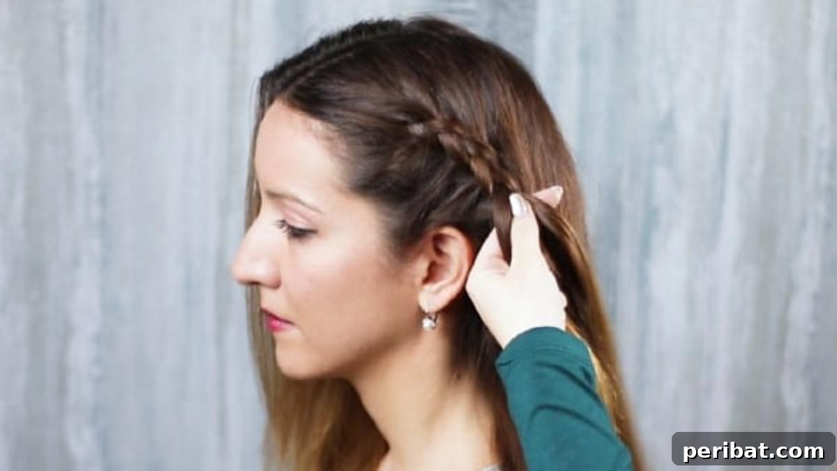 Gorgeous Double Dutch Braids: Step-by-Step Video Guide 8 Close-up of braiding hair, demonstrating the technique of incorporating new sections from the side