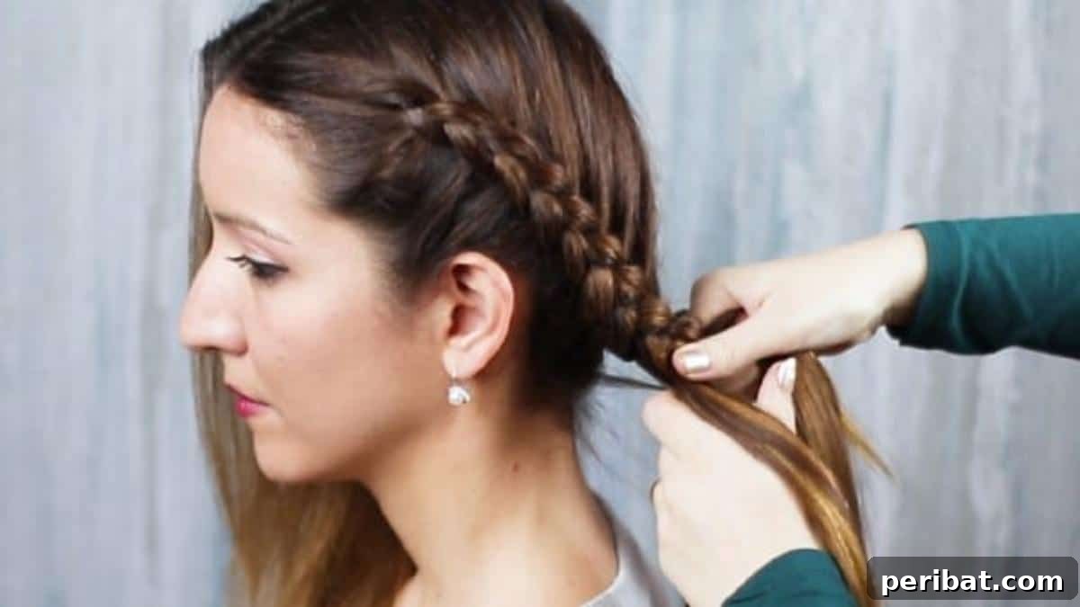Gorgeous Double Dutch Braids: Step-by-Step Video Guide 9 Continuing to braid hair down the length after incorporating all sections