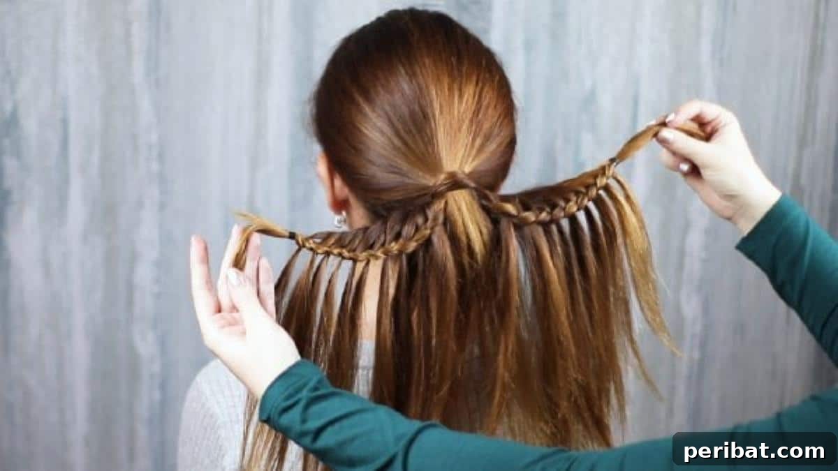 The fully braided ponytail with both sides showing the integrated fishtail pattern