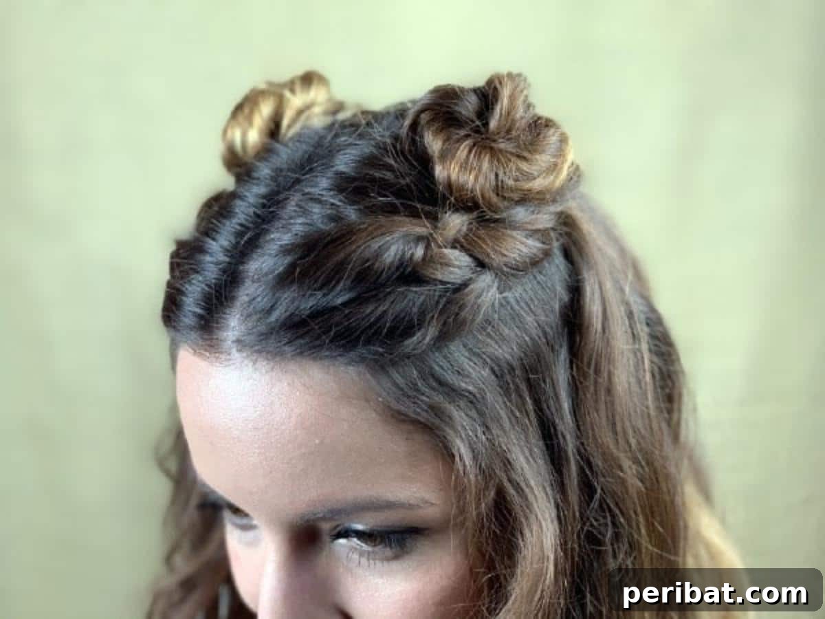 Chic Braided Twin Bun Half Updo 4 Close up of a single braided top knot hairstyle