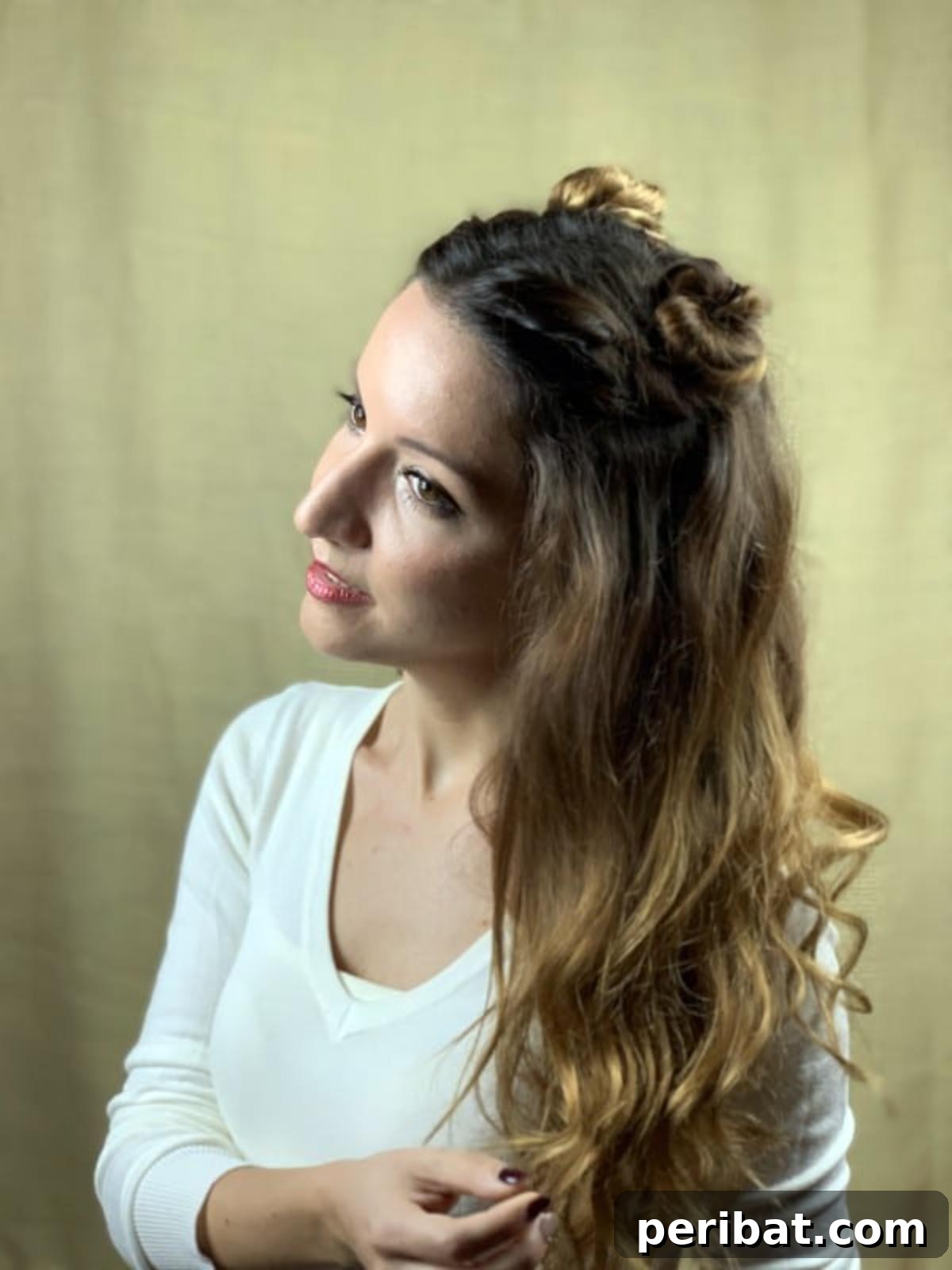Chic Braided Twin Bun Half Updo 5 Brunette woman with tilted head showing braided top knots and wavy hair
