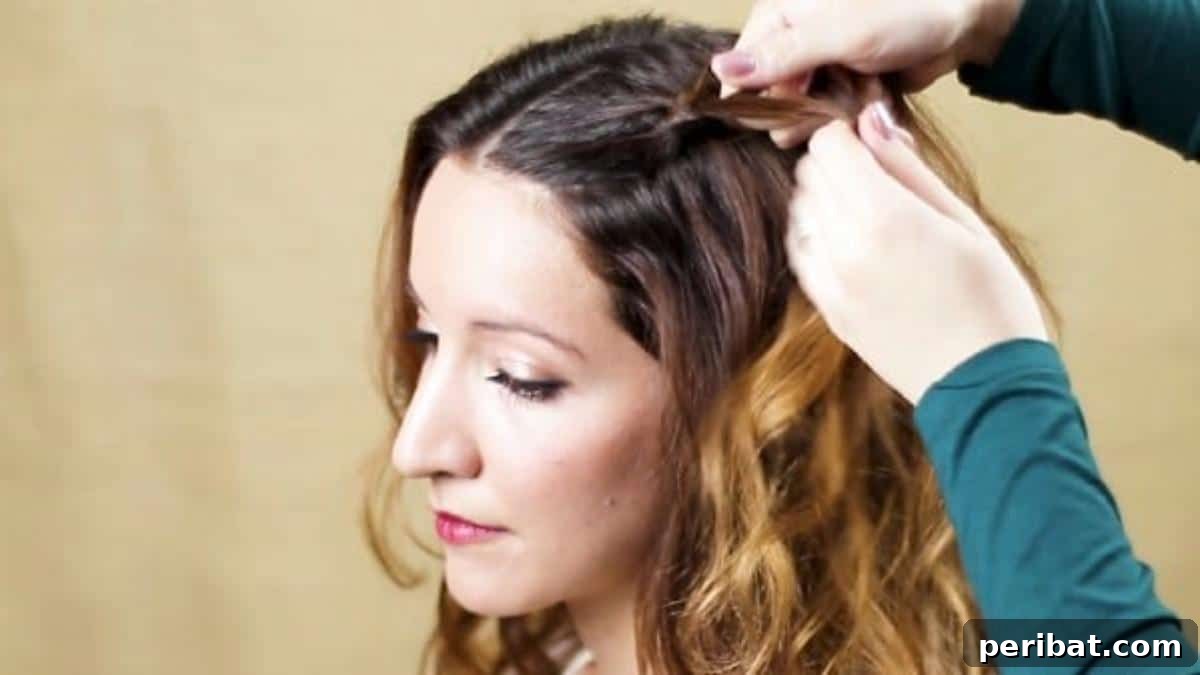 Chic Braided Twin Bun Half Updo 7 Beginning to braid the top side section of brown hair