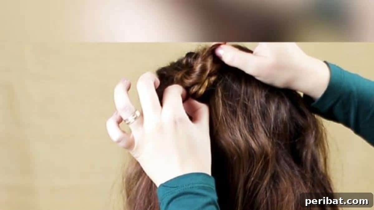 Chic Braided Twin Bun Half Updo 10 Securing the formed bun with bobby pins