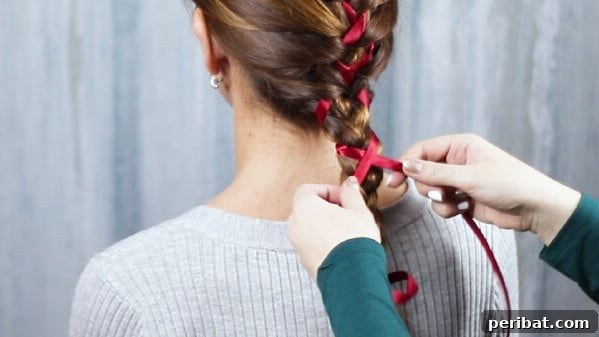 Sweet Ribbon Braid Style 12 Close-up of a finished braided hairstyle, showing a rich brown hair tone with a contrasting ribbon beautifully woven throughout, ready to be tied.