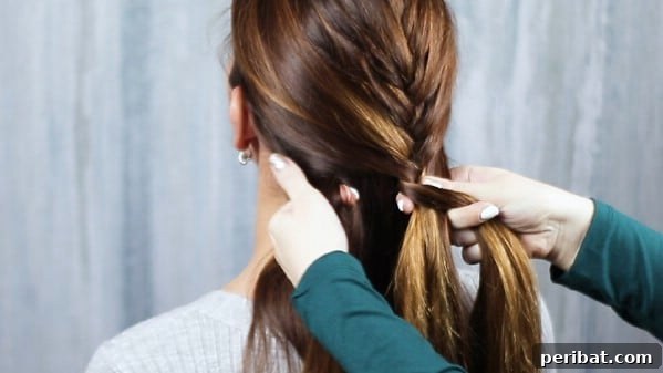 Sweet Ribbon Braid Style 7 Detailed shot of the French braiding process, illustrating how new sections of hair are incorporated into the main braid from the sides.