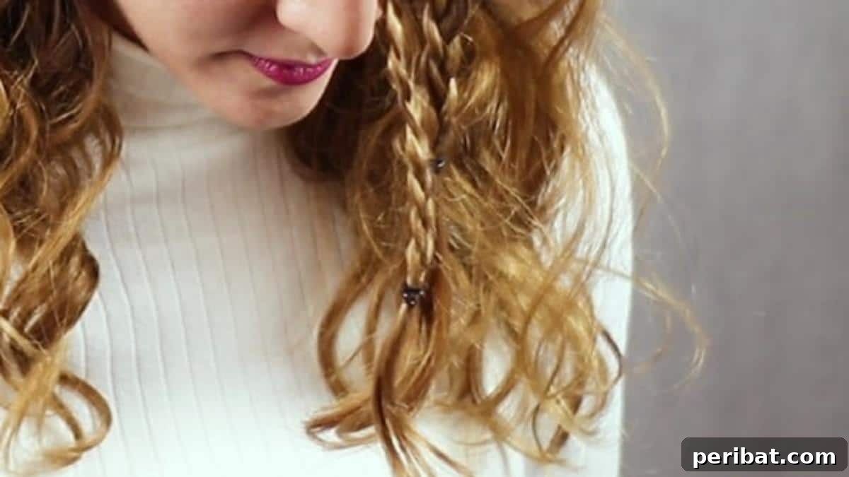 Regal Braided Crown Updo Video Steps 11 Step 4: Tying the two front braids together temporarily.