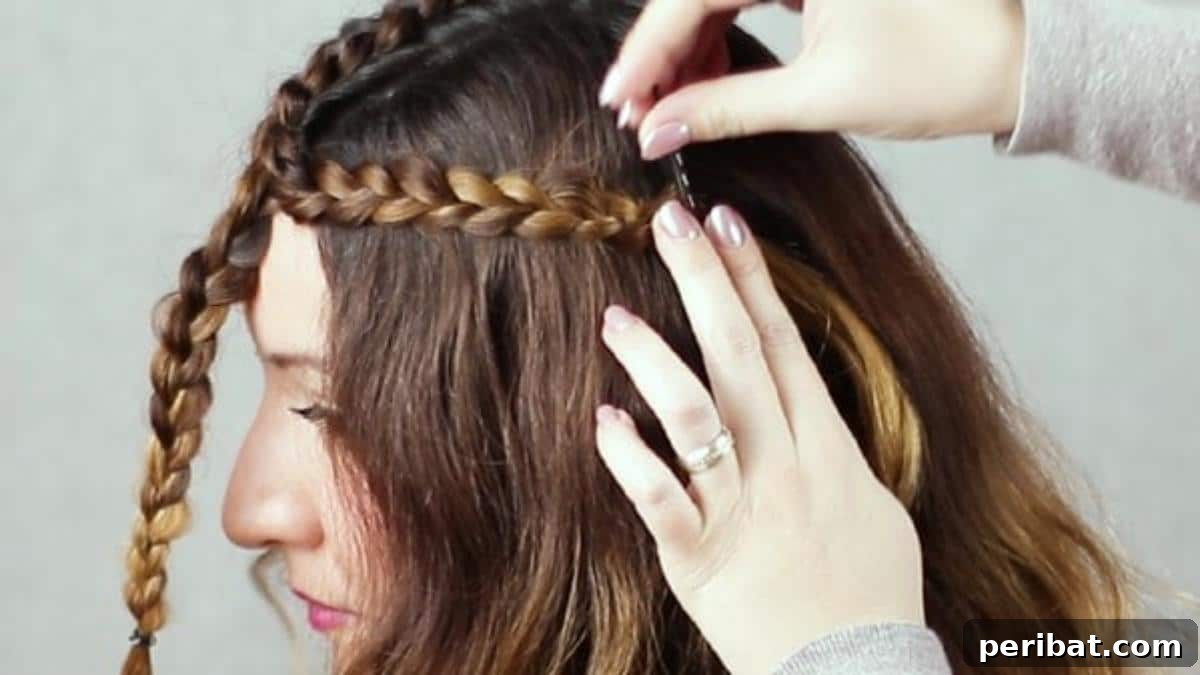 Regal Braided Crown Updo Video Steps 12 Step 5: Pinning one braid securely to the side of the head.
