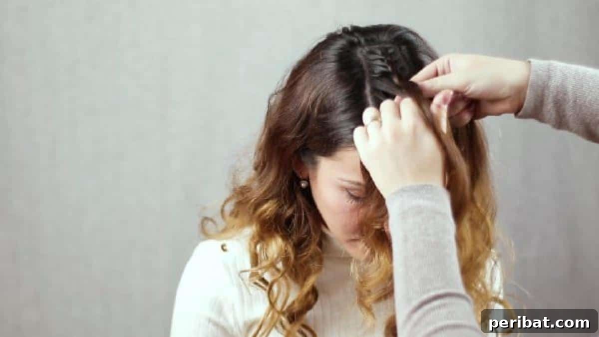 Regal Braided Crown Updo Video Steps 6 Step 2: Braiding the central section of hair forward towards the forehead.