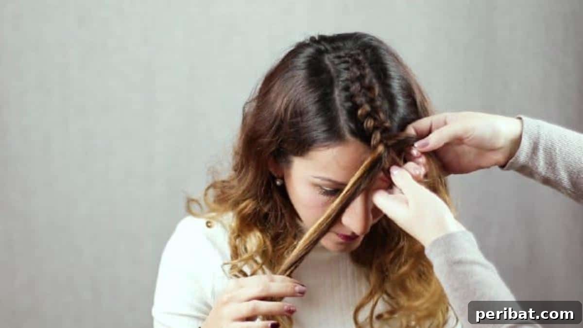 Regal Braided Crown Updo Video Steps 8 Step 3: Dividing the remaining front hair into two sections for side braids.