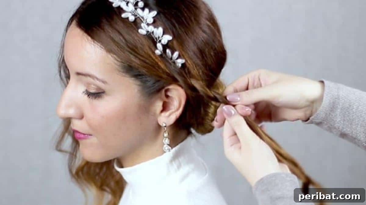 Chic Low Braided Updo Tutorial 12 Beginning to braid the front section of hair, starting above the ear and directing it towards the bun