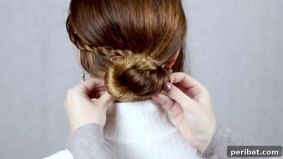 Chic Low Braided Updo Tutorial 14 Artfully looping the finished braid around the secured low bun, pinning it into place