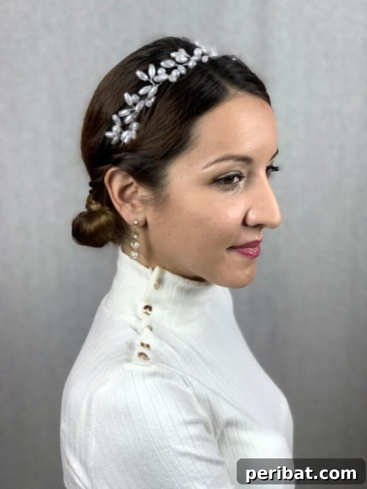 Chic Low Braided Updo Tutorial 4 Close-up of a perfectly styled brown hair low braided bun with subtle bead accents