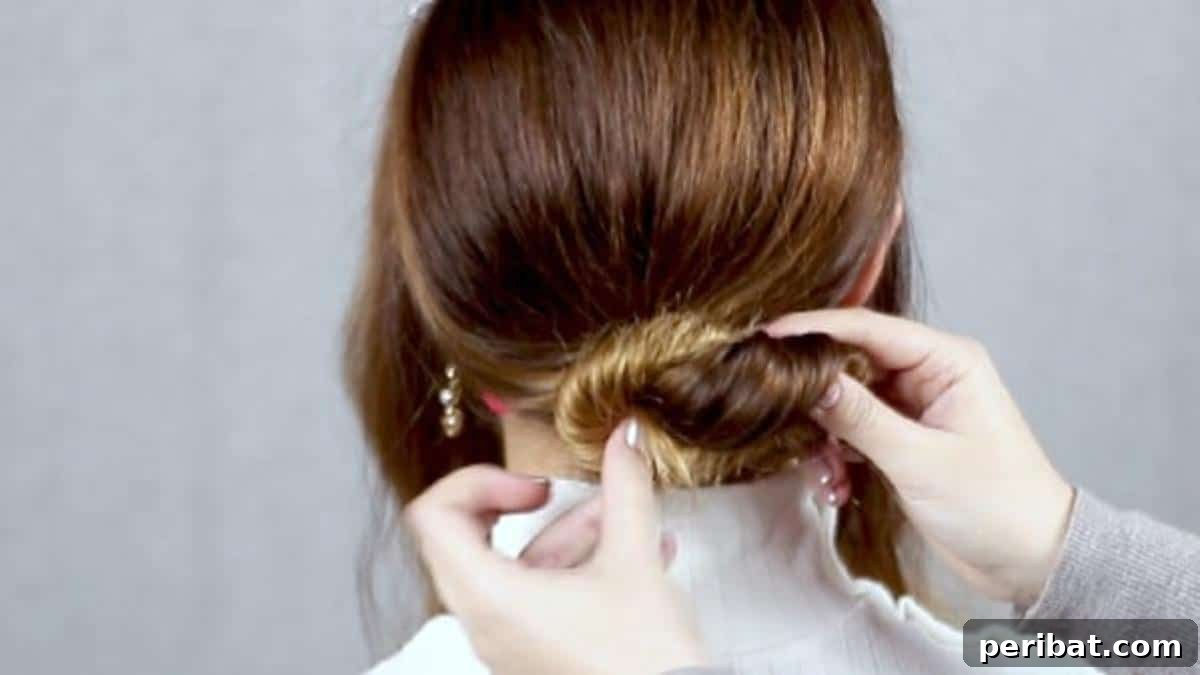 Chic Low Braided Updo Tutorial 10 Twisting and looping hair to create a refined hair knot bun at the base of the head