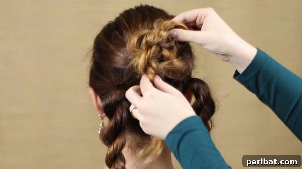Quick and Chic Braided Messy Bun Video 12 Pinning the middle twist braid into the foundational bun shape