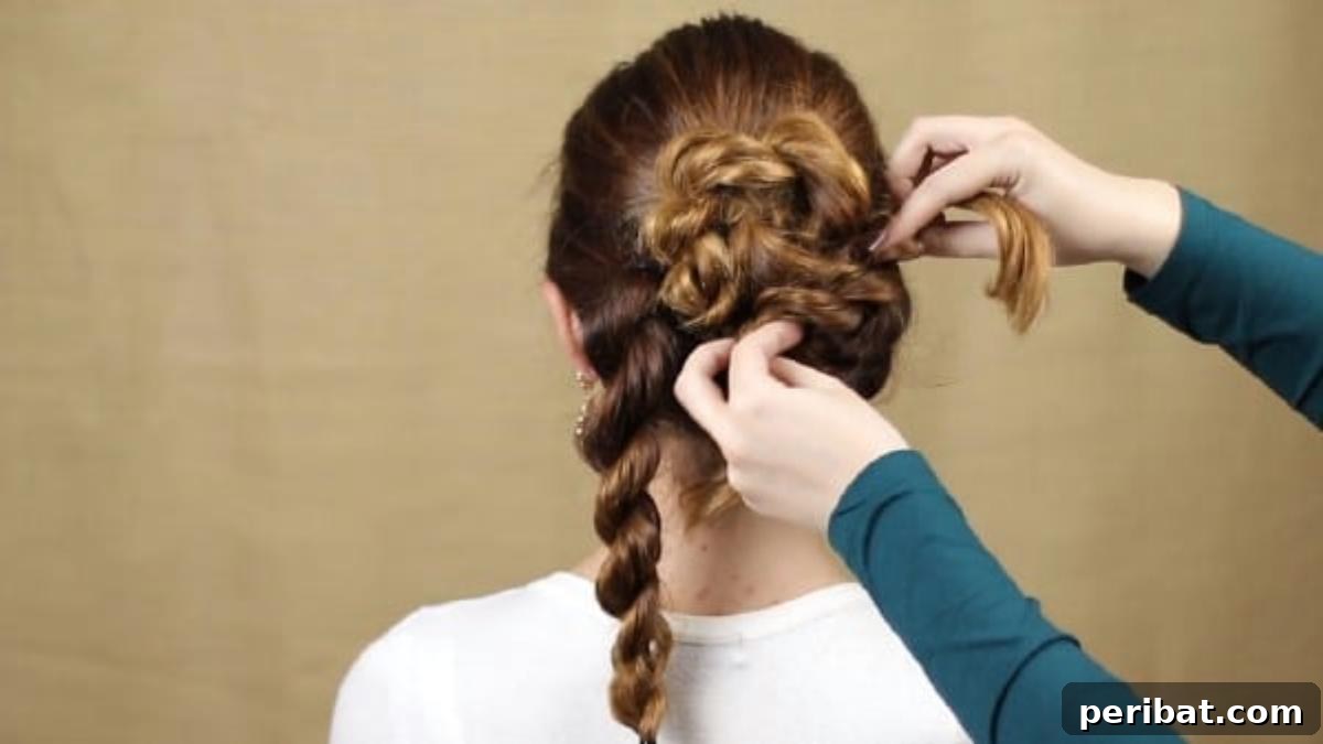 Quick and Chic Braided Messy Bun Video 13 Twisting and pinning a side braid to begin layering the bun