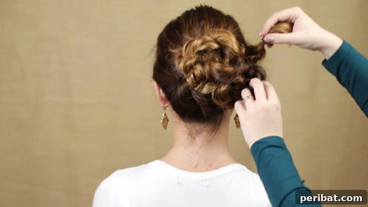 Quick and Chic Braided Messy Bun Video 14 Securing the final braid to complete the intricate braided bun
