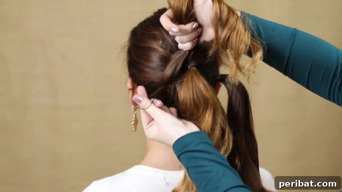Quick and Chic Braided Messy Bun Video 7 Gathering the left side section of hair into a ponytail to complete sectioning