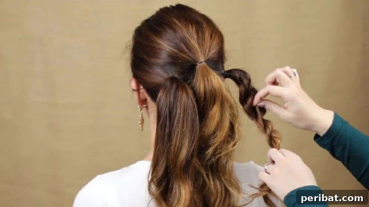 Quick and Chic Braided Messy Bun Video 9 Gently fluffing and expanding the twisted braid for added body