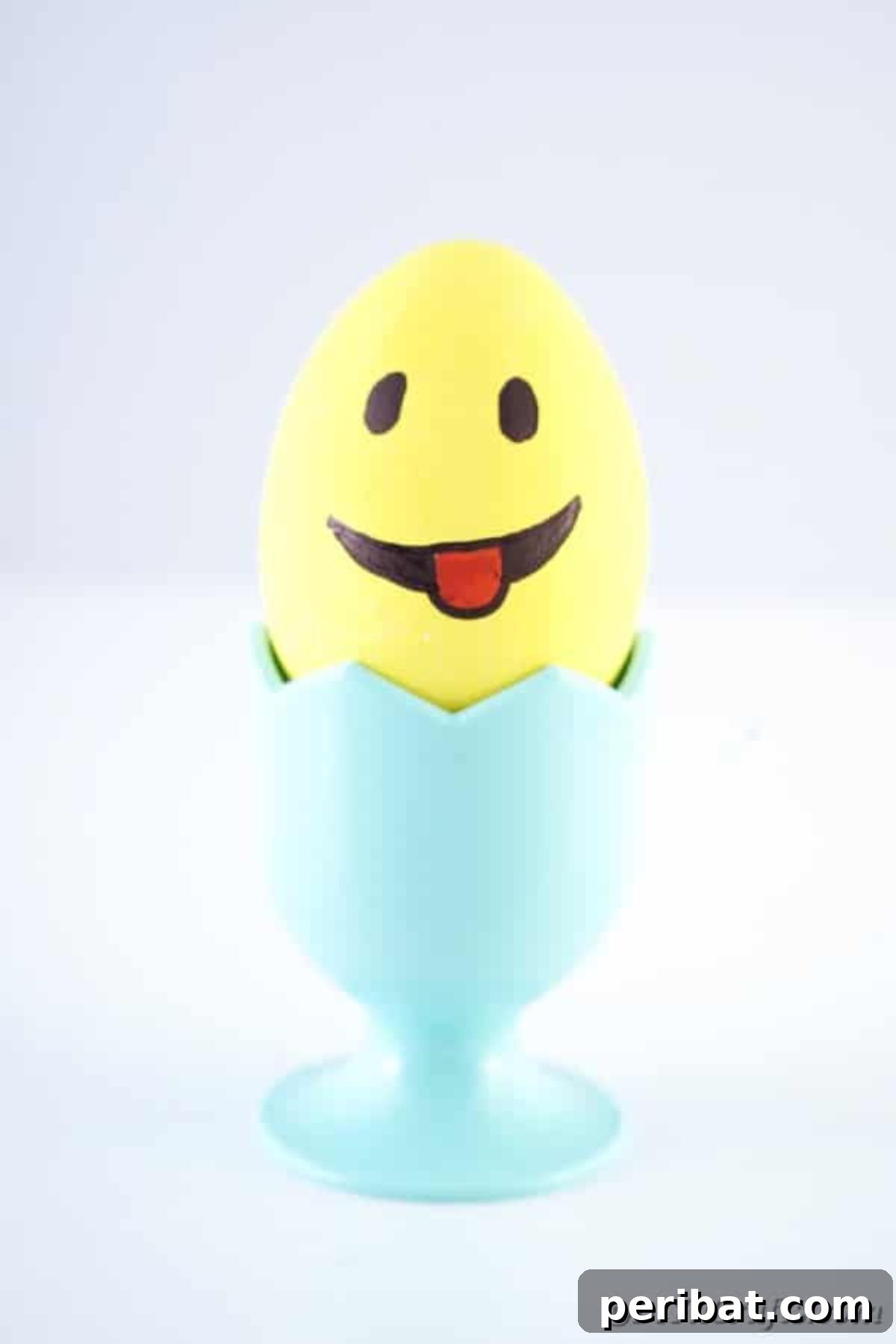 Crafting Cheerful Emoji Easter Eggs 4 Yellow Easter egg in blue egg cup