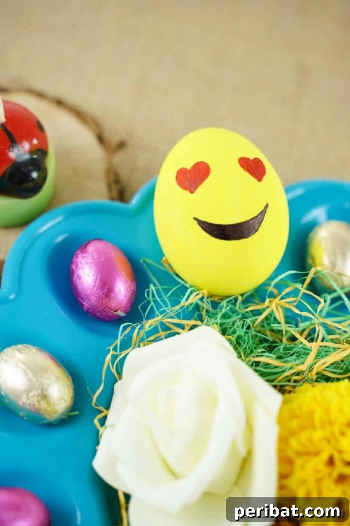 Crafting Cheerful Emoji Easter Eggs 7 Heart eye emoji egg on blue egg plate