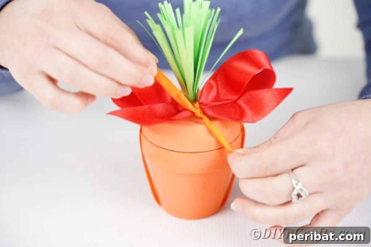 Handcrafted Easter Carrot Pots 14 Adding red ribbon top of flower pot