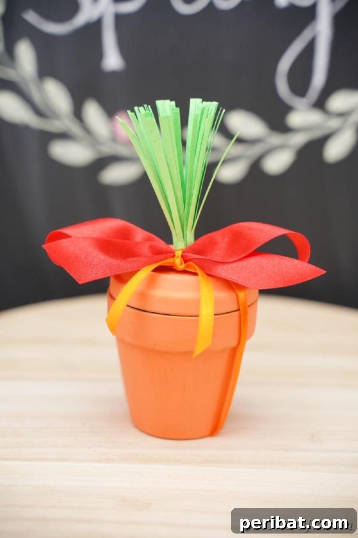 Handcrafted Easter Carrot Pots 4 Flower pot in front of chalkboard with red ribbon