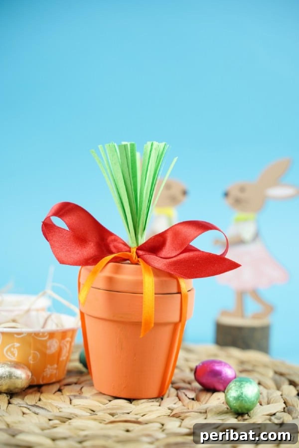 Handcrafted Easter Carrot Pots 5 Flower pot carrot on woven mat in front of blue background