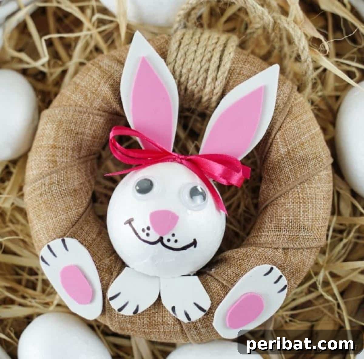 DIY Adorable Easter Bunny Wreath Video Guide 5 Rustic Easter bunny wreath decorated with hay and colorful eggs, enhancing its farmhouse appeal.