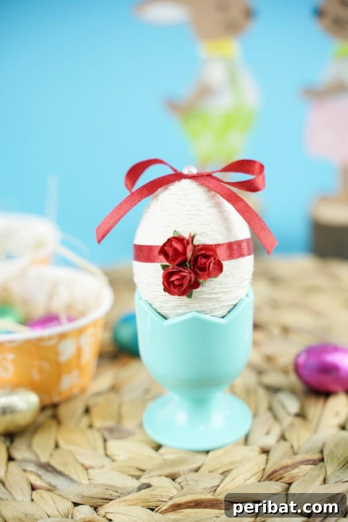 Crafting Yarn Wrapped Easter Eggs 13 Finished yarn egg displayed in an egg cup on a woven mat