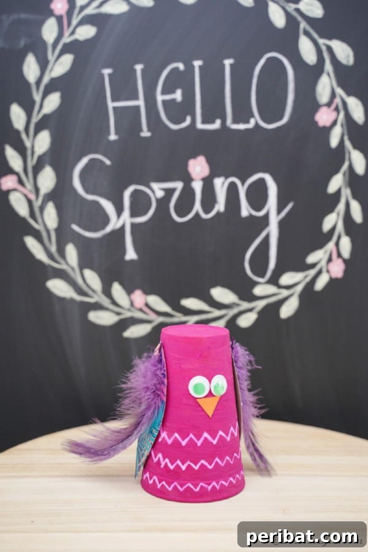 Turn Plastic Cups Into Charming Owls 5 Colorful plastic cup owl craft standing proudly in front of a chalk board.