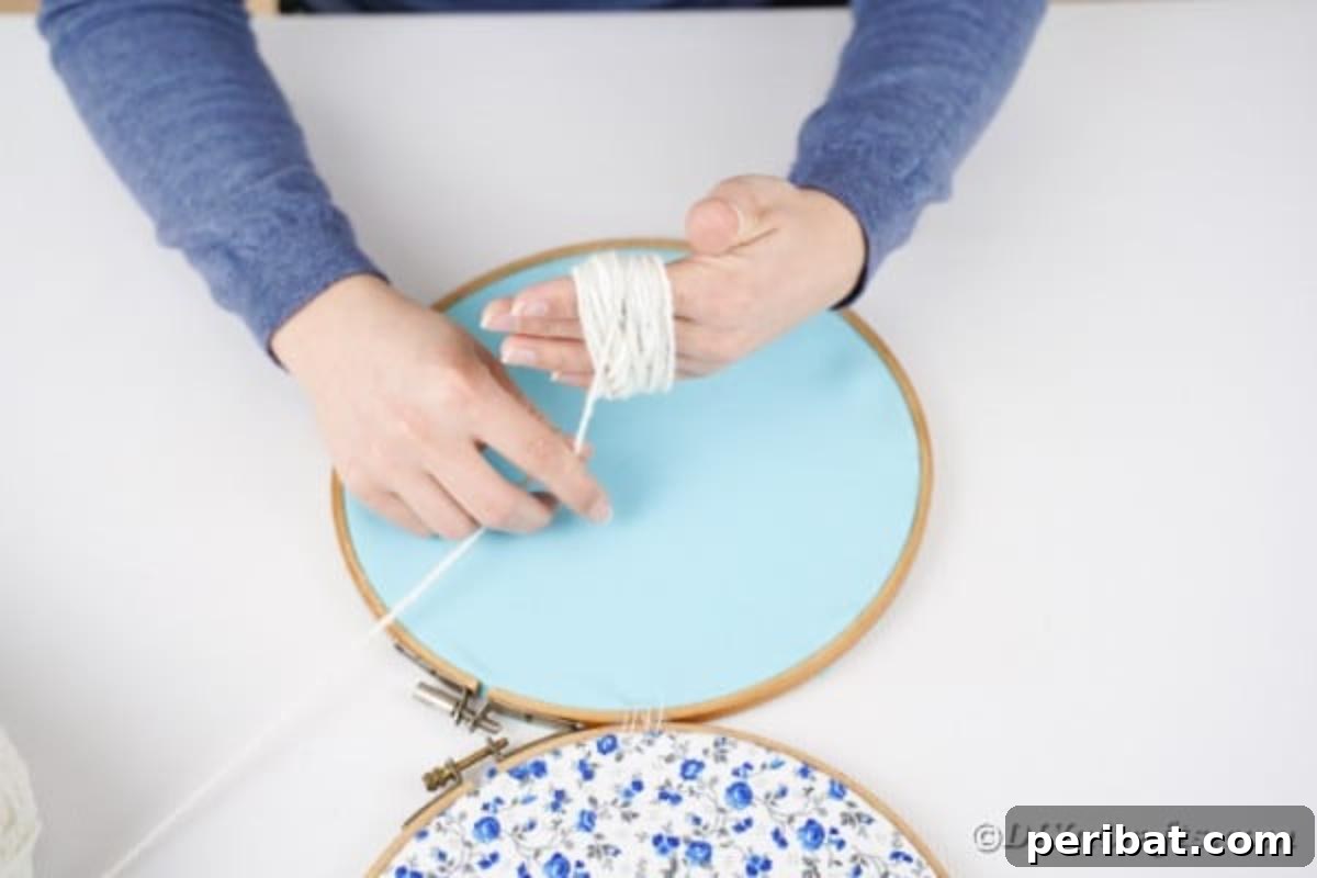 Hoppy Easter Bunny Wall Art DIY 11 Steps for making a yarn pom pom by wrapping yarn around hand