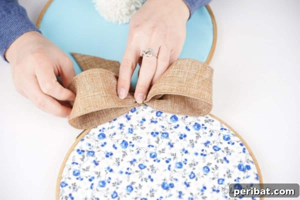 Hoppy Easter Bunny Wall Art DIY 18 Gluing the burlap bow to the front of the bunny, covering the hoop seam