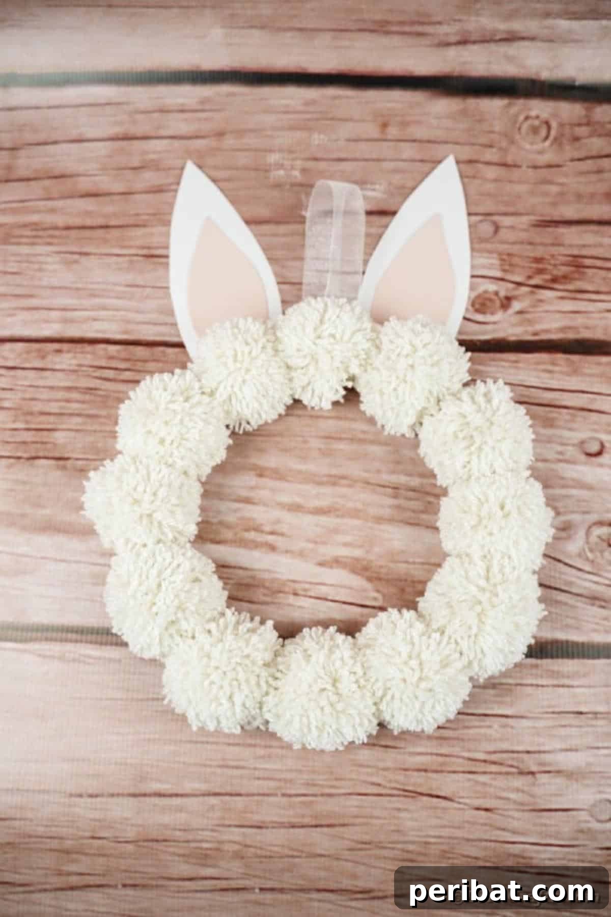 Fluffy Pom Pom Easter Bunny Door Wreath 5 DIY Pom Pom Easter Bunny Wreath in various colors, showcasing creative possibilities.