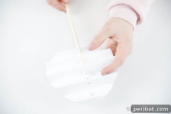 DIY Easter Paper Bunny Craft Free Printable Template 23 Threading the dowel rod through the accordion-folded bunny body