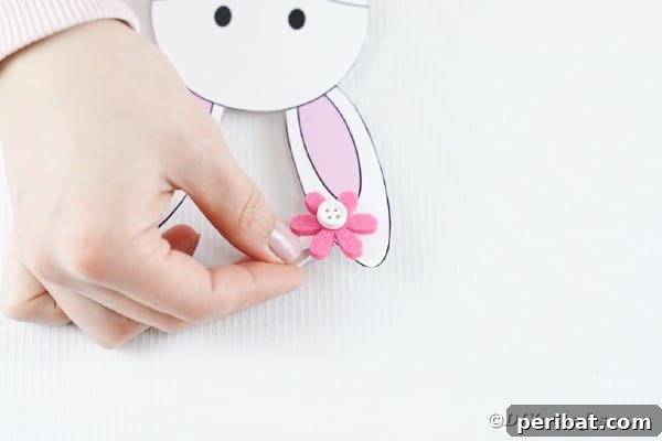 DIY Easter Paper Bunny Craft Free Printable Template 26 Attaching a small flower embellishment to one of the bunny's ears