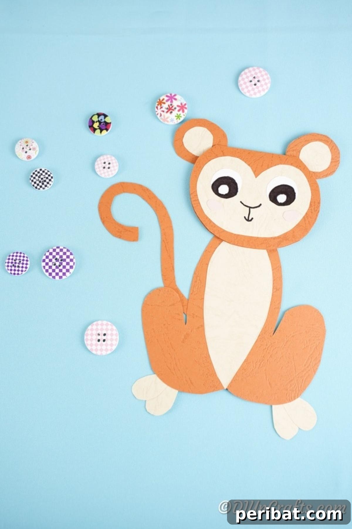 DIY Monkey Card Fun for Kids 4 A handmade DIY monkey card elegantly placed on a solid blue paper background, showcasing its delightful details and craftmanship.