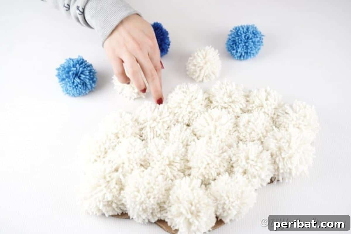 Arranging the yarn strings for the dangling raindrop pom poms