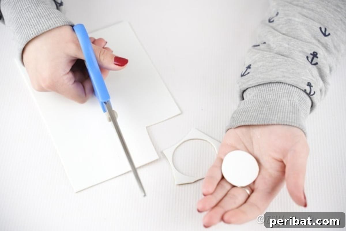 White paper being cut into a circle for the eye base