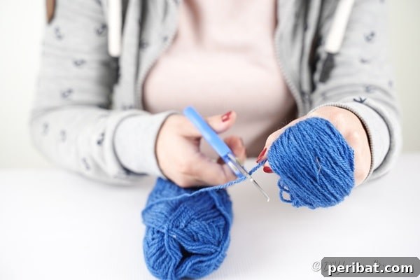 Wrapping yarn around hand for pom pom