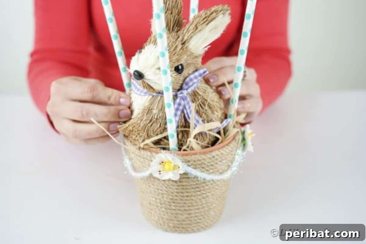 Hoppy Hot Air Balloon Easter Craft 14 Placing a stuffed bunny inside the basket of the hot air balloon craft