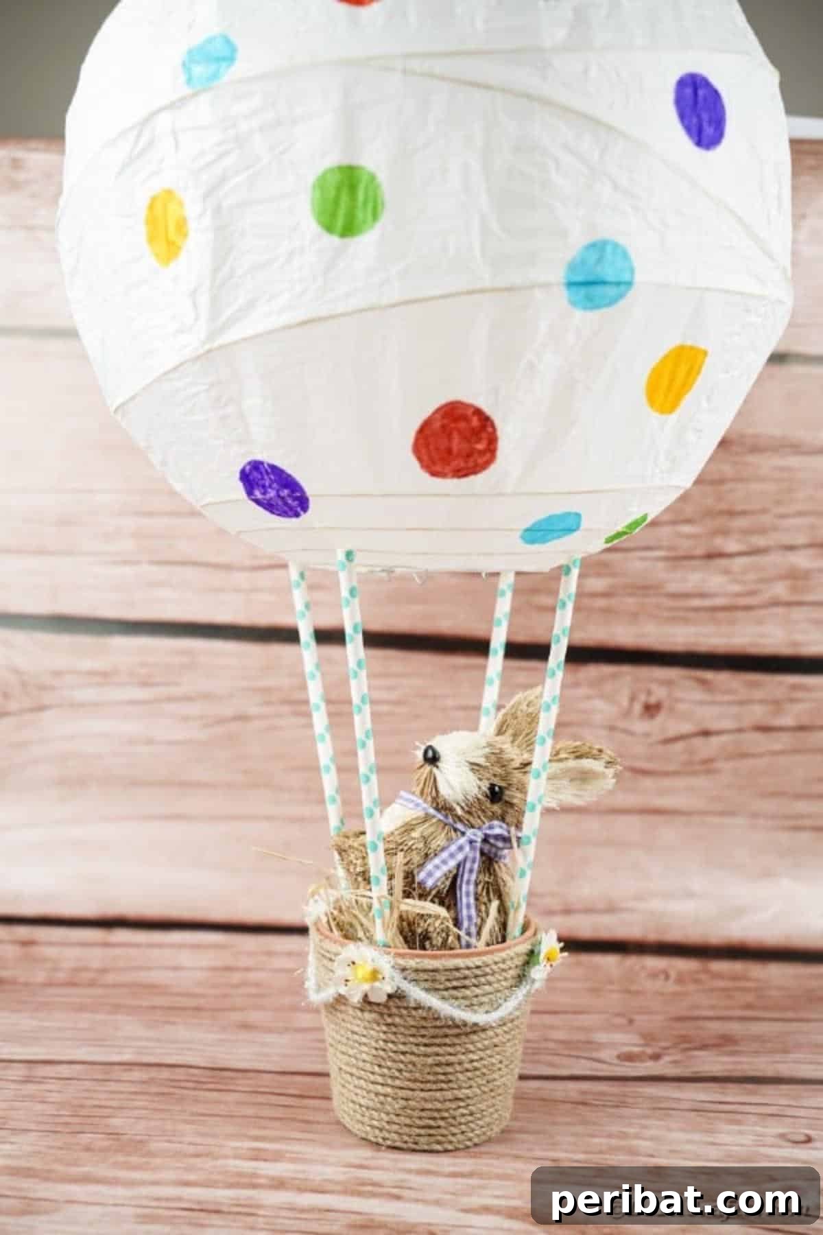 Hoppy Hot Air Balloon Easter Craft 16 The completed Easter bunny balloon craft displayed beautifully on a wooden table, ready for celebration