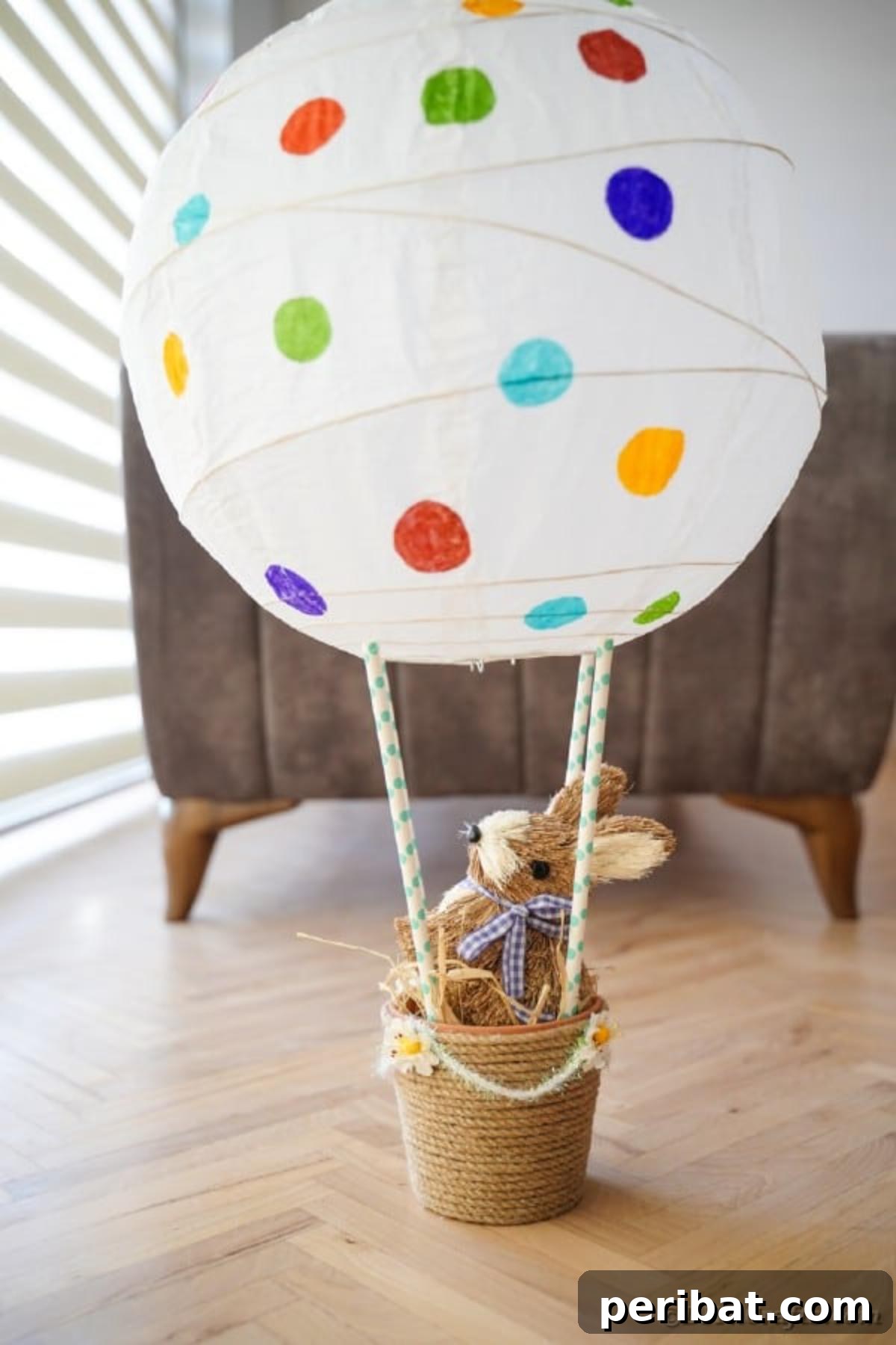Hoppy Hot Air Balloon Easter Craft 3 Completed Easter hot air balloon craft placed on the floor next to a cozy chair, adding a festive touch to the room